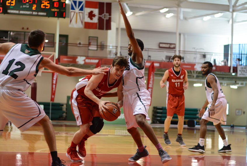 Jason Thompson of the Memorial Sea-Hawks tries to split a pair of UPEI Panthers in an AUS basketball game at the Field House earlier this season. The point guard averaged 10.6 points per game in his third season at Memorial in 2019-20. — Taz Uddin photo/Memorial University