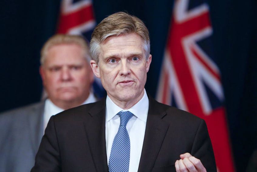 Ontario Finance Minister Rod Phillips speaks to the media about the state of emergency amid the coronavirus pandemic, while Premier Doug Ford looks on, on March 18, 2020. Phillips has come under heavy criticism for a vacation to the Caribbean while Ontario was locked down over Christmas.