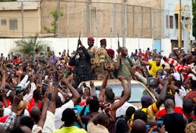 A crowd cheers Malian army soldiers at Independence Square in Bamako on Tuesday after a mutiny. REUTERS/Moussa Kalapo
