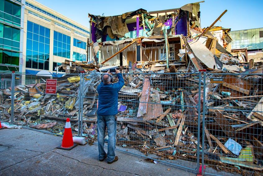 A passerby takes a photo of the partially demolished Mills Brothers building near the intersection of Spring Garden Road and Birmingham Street on Nov. 22.
Ryan Taplin - The Chronicle Herald