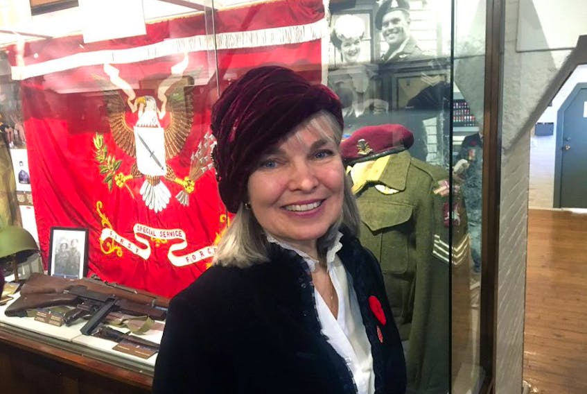 Rosealee Peppard Lockyer stands in front of a Remembrance Day display on Friday at the Army Museum Halifax Citadel. The display commemorates her war-hero father Herb Peppard. - John DeMont