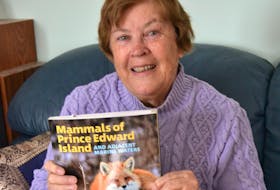 Rosemary Curley holds a copy of Mammals of Prince Edward Island and Adjacent Marine Waters, a book she co-wrote with co-authored with Pierre-Yves Daoust, Donald F. McCalpine Kimberly Riehl and J. Dan McAskill. It’s published by Island Studies Press at UPEI. 