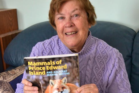 Rosemary Curley holds a copy of Mammals of Prince Edward Island and Adjacent Marine Waters, a book she co-wrote with co-authored with Pierre-Yves Daoust, Donald F. McCalpine Kimberly Riehl and J. Dan McAskill. It’s published by Island Studies Press at UPEI. 