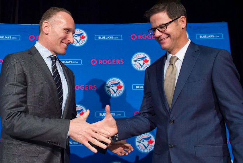 Toronto Blue Jays new general manager Ross Atkins, right, and Blue Jays president and CEO Mark Shapiro shake hands after answering questions during a press conference in Toronto on Friday, December 4, 2015.