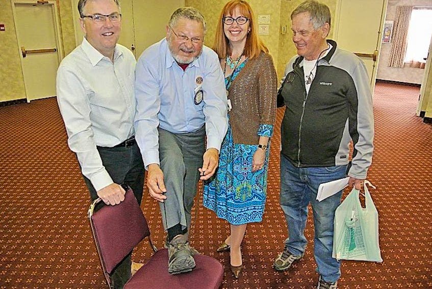 Longtime Amherst Rotarian Morris Haugg ties his sneakers in preparation for the club’s Walk to Camp Tidnish on Saturday, June 17. Looking on are (from left) Rotary president Ron Wilson and Rotarians Gwen Kerr and Bob Janes, who chairs the club’s Camp Tidnish committee.
