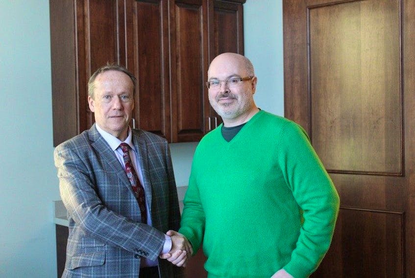 <span>Bob Ashely, left, CAO, City of Summerside, greets Daniel Mullen. Mullen is taking over Summerside’s Route 2 internet service and creating a new business called Island Telecom Inc.<br /></span>