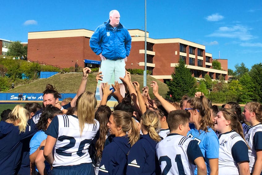After earning a 36-17 home victory over the Acadia Axewomen in AUS rugby action, Sept. 22 at Oland Stadium, the St. F.X. X-Women had some fun during their victory celebration with a cardboard cut-out of veteran head coach Mike Cavanagh. Corey LeBlanc