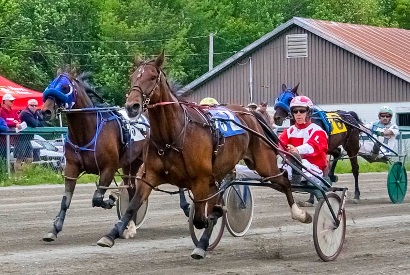 Runaway Mystery and Harold LeBlanc Jr, #2, fend off a stretch drive challenge from Accelerator and Greg Sparling, to win Saturday afternoon at Northside Downs. CONTRIBUTED/TANYA ROMEO
