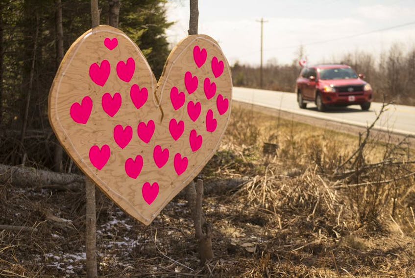 A car passes by a wooden heart along Highway 2 near Highland Village on Thursday, April 23, 2020. The heart was created to remember the victims of the weekend's mass shooting. 
Ryan Taplin - The Chronicle Herald