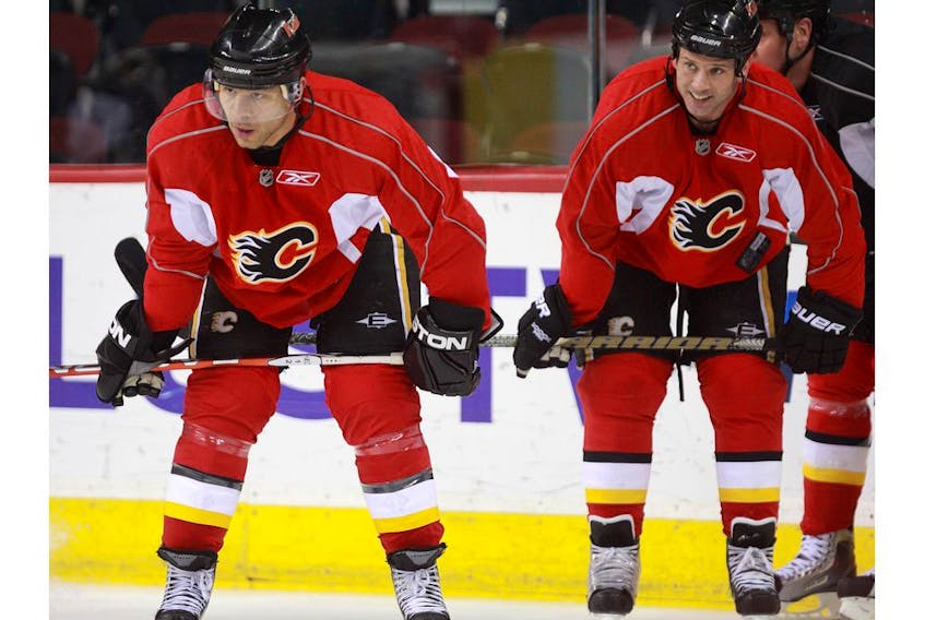 Then-teammates with the Calgary Flames, Jarome Iginla, left, and Craig Conroy catch their breath during practice at the Saddledome in this photo from January 2010. Postmedia file photo.