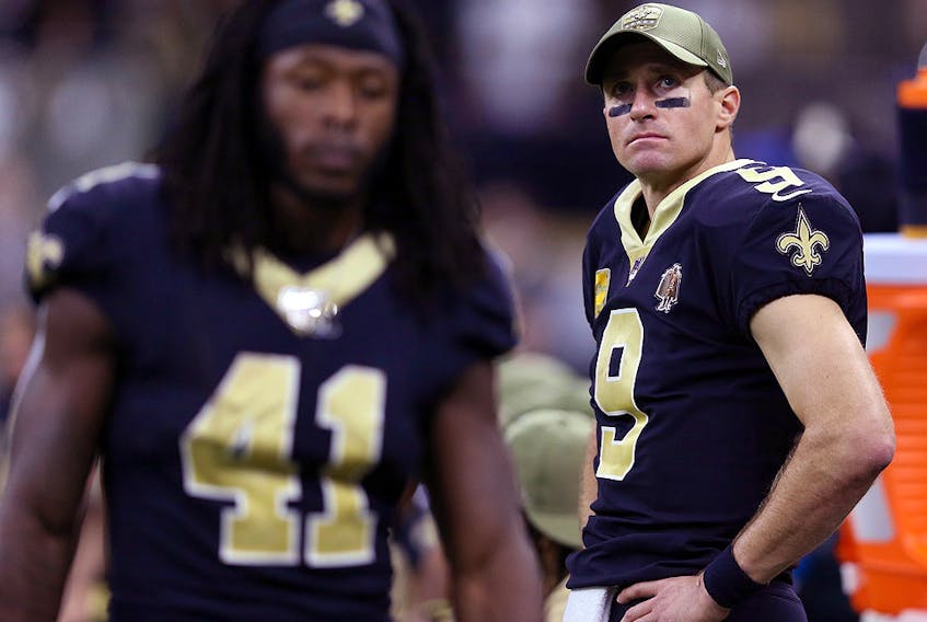 New Orleans Saints quarterback Drew Brees (9) looks on from the bench against the Atlanta Falcons at the Mercedes-Benz Superdome. Saints running back Alvin Kamara (41) is at left. (Chuck Cook-USA TODAY Sports)
