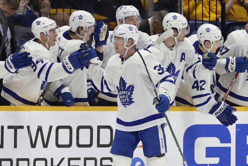 Maple Leafs defenceman Rasmus Sandin is congratulated after scoring his first NHL goal, against the Nashville Predators on Monday night. (Mark Humphrey/The Associated Press)