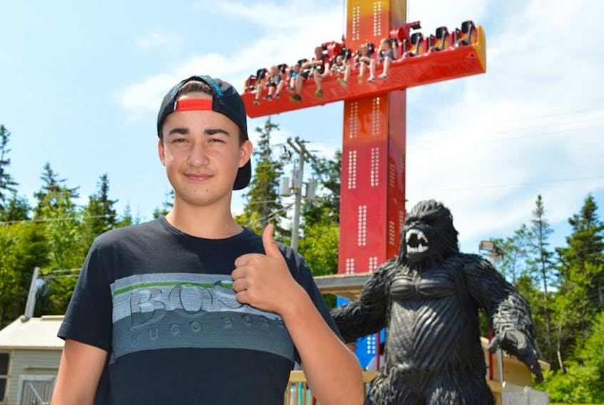 <p>Dawson Ross, 14, of Saint John gives Sandspit’s newest ride Cliffhanger a thumbs up. He said it’s much easier on his stomach that the old Rok-n-Rol was. The gorilla in the background was made by an artist in Thailand who used nothing but recycled tires.</p>