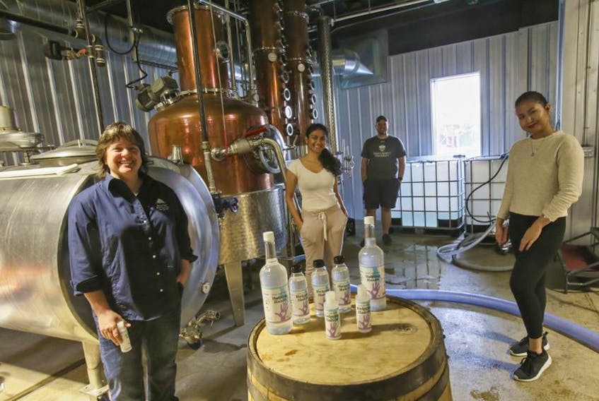 Julie Shore, co-owner and distiller, Prashansa Kooshna, Brandon Logan and Julie Anne Dayrit are seen with some of Halifax Distilling Co.'s Helping Hands hand sanitizer at the distillery, Friday, May 29, 2020.