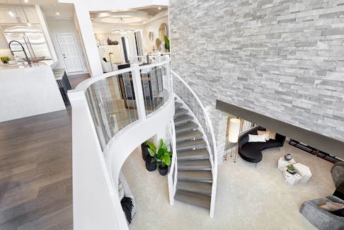 The curving staircase from the main level to the walkout basement in the Sapphire show home by Jayman Built in Edgewater Estates. Courtesy, Jayman Built
