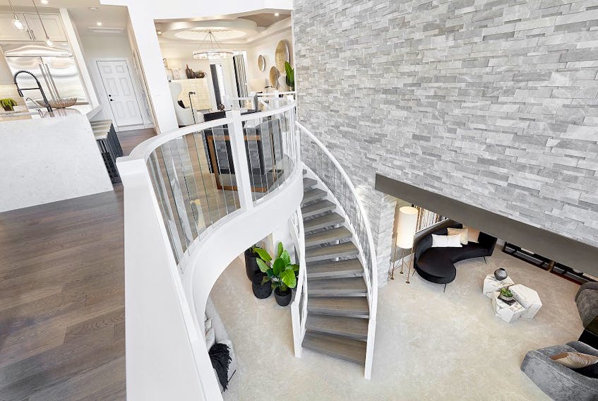 The curving staircase from the main level to the walkout basement in the Sapphire show home by Jayman Built in Edgewater Estates. Courtesy, Jayman Built
