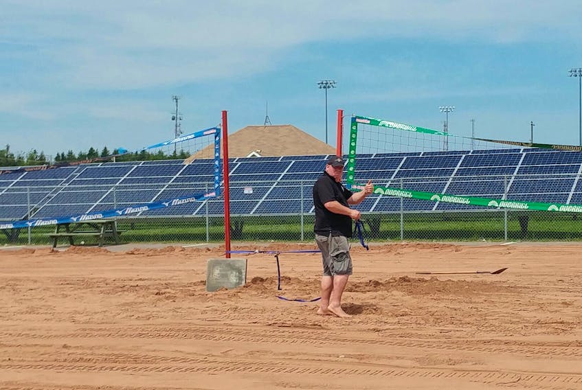 Event organizer Aaron Doyle sets up a net the 15th annual Lobster-Fest beach volleyball tournament in Summerside this weekend.