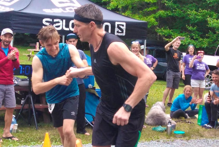 Steven Reeves, right, and Jean-Marc Boudreau bump knuckles as they head out on the 28th and final loop of the Sonofa Gunofa Run in Five Islands, N.S., recently. Reeves won the event by about 15 seconds.