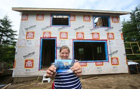 Megan Whitman holds a photo of the house that she and her parents are renovating, in Lake Charlotte, July 16, 2020. 
TIM KROCHAK/ The Chronicle Herald 