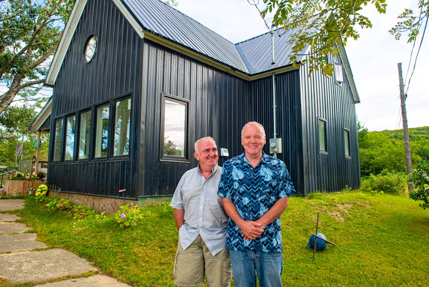 Fraser Hill (left) and Vincent Fraser-Hill in front of their Valley Mills, Cape Breton house they call Taigh Dubh (dark house).
Ryan Taplin - The Chronicle Herald