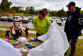 Carrie and Sean Mulrooney, visiting Charlottetown from Cape Breton, couldn't help but stop to take a look at these scarecrows holding a seance in front of Beaconsfield Historic House on Oct. 8.