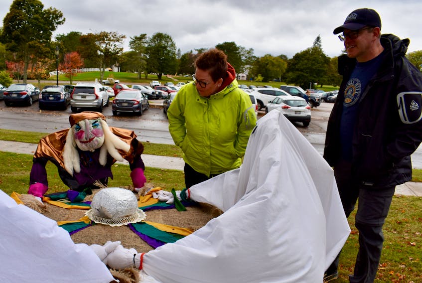 Carrie and Sean Mulrooney, visiting Charlottetown from Cape Breton, couldn't help but stop to take a look at these scarecrows holding a seance in front of Beaconsfield Historic House on Oct. 8.