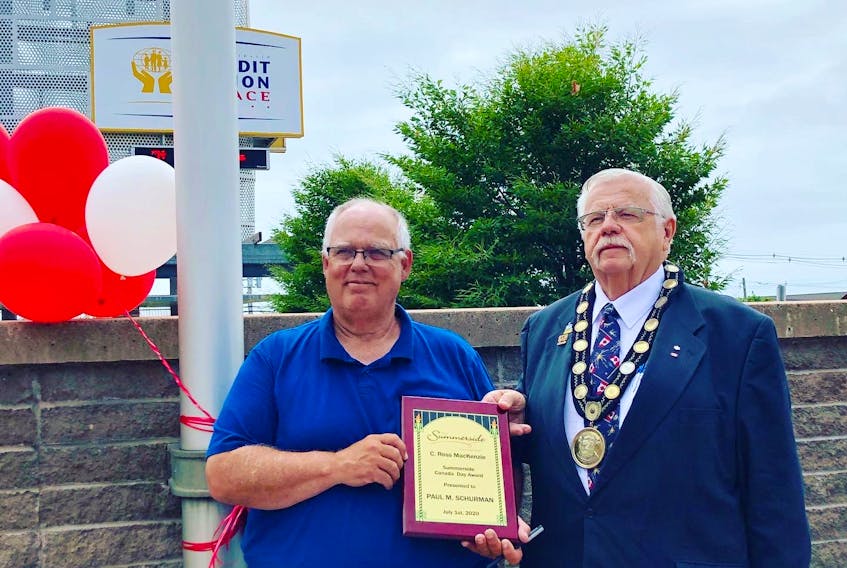 Summerside Mayor Basil Stewart, right, presents Paul M. Schurman with the C. Ross MacKenzie Canada Day Award on Wednesday. The award is presented in recognition of outstanding contributions to Canadian pride in the City of Summerside on Canada Day.