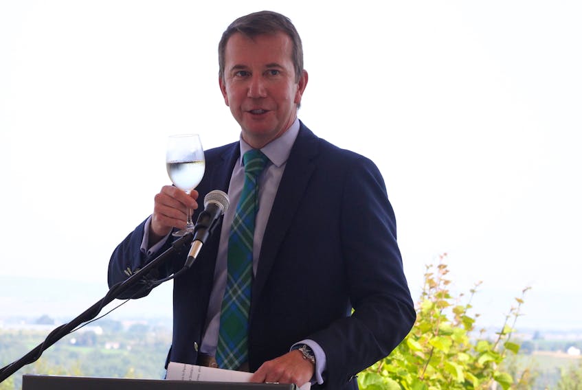 Kings-Hants member of parliament and treasury board president Scott Brison holds and later took a sip of white wine from Luckett Vineyards, where he announced nearly $640,000 in federal funding to help Nova Scotia’s wine industry further expand into global markets.