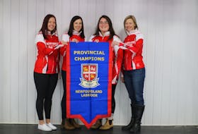 The members of the Sarah Hill-skipped rink hold up the championship banner after taking the 2021 Scotties Newfoundland and Labrador women's curling crown Saturday in St. John's by defeating Mackenzie Mitchell's team in a championship series. From left, Hill, Beth Hamilton, Laren Barron and Adrienne Mercer. — Contributed/Alex Phillips