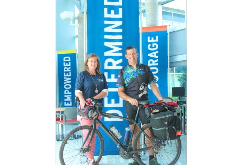Audrey Arsenault, academic chair for the School of Access at NSCC Pictou Campus, and John Smith, manager of student services at NSCC’s Kingstec and Annapolis Valley campuses, pose beside a banner that represents the theme of Smith’s Determination Ride. The approximately 3,400-km bicycle trip around Nova Scotia serves both as an adventure for Smith and a fundraiser for a bursary for Adult Learning Program graduates continuing their education at Nova Scotia Community College campuses.