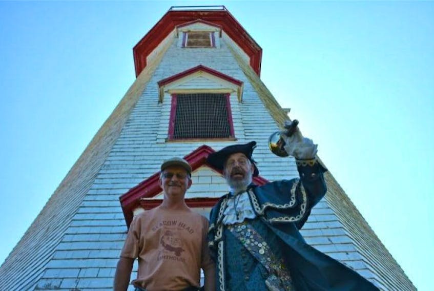 Thomas Sherry, left, and Frank Gorham stand in front of the Seacow Head lighthouse.