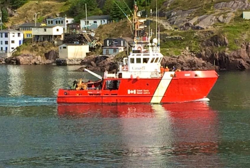 <p>The Canadian Coast Guard cutter vessel Harp heads out through The Narrows around 10:15 a.m. today to aid in the search for missing boaters. — Photo by Joe Gibbons/The Telegram</p>