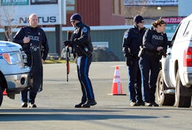 Members of the Royal Newfoundland Constabulary surrounded the house at 374 Empire Avenue Monday after receiving information that an assault suspect was there. Keith Gosse/The Telegram