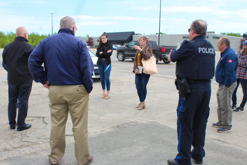 Heather Peters, facing the group on the left, talks with representatives from Cape Breton Regional Police, the Grand Lake Road Volunteer Fire Department and other Riverview High School parents in the parking lot of the Mayflower Mall on Friday. Beside Heather facing the group is her daughter Madison MacInnis who is in her graduating year. The group was discussing plans for the school's upcoming drive-in grand march celebration taking place on June 21, which was confirmed the evening before their meeting. NICOLE SULLIVAN/CAPE BRETON POST 
