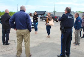 Heather Peters, facing the group on the left, talks with representatives from Cape Breton Regional Police, the Grand Lake Road Volunteer Fire Department and other Riverview High School parents in the parking lot of the Mayflower Mall on Friday. Beside Heather facing the group is her daughter Madison MacInnis who is in her graduating year. The group was discussing plans for the school's upcoming drive-in grand march celebration taking place on June 21, which was confirmed the evening before their meeting. NICOLE SULLIVAN/CAPE BRETON POST 