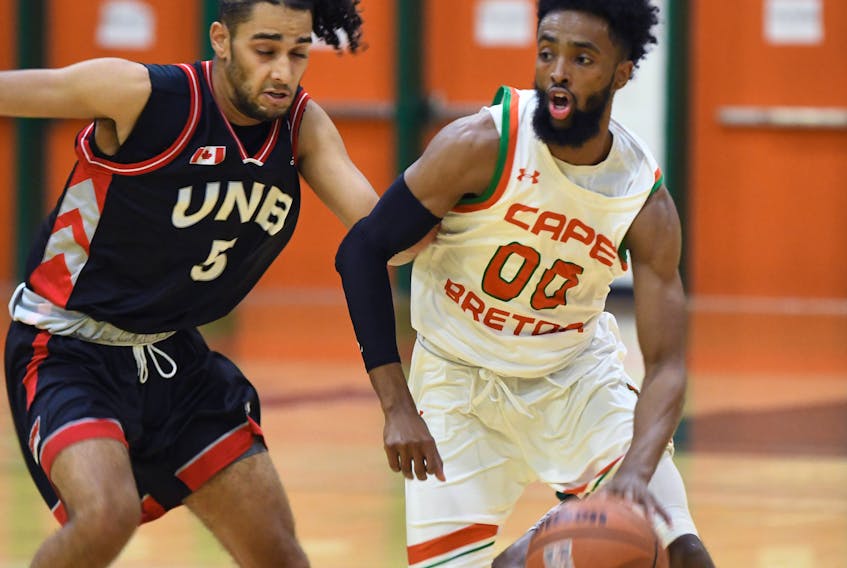 Cape Breton Capers star Osman Omar, right, moves past Jaden Matthews from the University of New Brunswick during a game at the Sullivan Field House on the Cape Breton University campus this season. The two teams will meet in the Atlantic University Sport playoffs today in Halifax. CONTRIBUTED/VAUGHAN MERCHANT, CBU