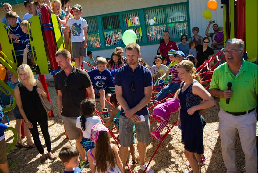 Stan Watchorn (far right), principal at Kent elementary school in Agassiz, with Johanna and Henrik Sedin, and Daniel and Marinette Sedin (in front left to right), at the opening of the school's new playground in the fall of 2014, thanks to a $50,000 grant from the Sedin Family Foundation. ‘The really cool part, the part I really love, the Sedins came out with their wives and had a ribbon-cutting ceremony,’ recalls Watchorn. ‘Every person felt special because of how the twins and their wives treated them.’