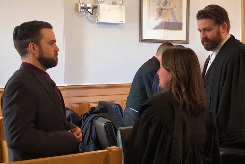 Philip Butler speaks to his lawyers, Karen Rehner and Tim O’Brien, during a recess in his second-degree murder trial Thursday in St. John’s. The trial has concluded and the jury has been sequestered to begin their verdict discussions. Tara Bradbury/The Telegram
