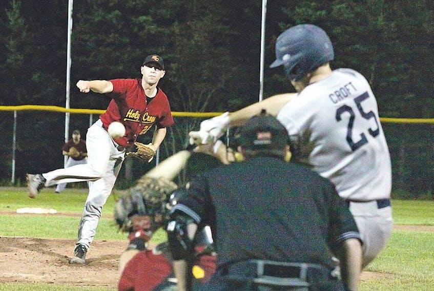 The Holy Cross Crusaders’ Sean Janes delivers a pitch to the Gonzaga Vikings’ Troy Croft in Game 7 of the St. John’s senior baseball league final Monday night at St. Pat’s Ball Park. The Vikings won 4-0 to complete a comeback from a 3-1 series deficit and claim their first title since 2008.