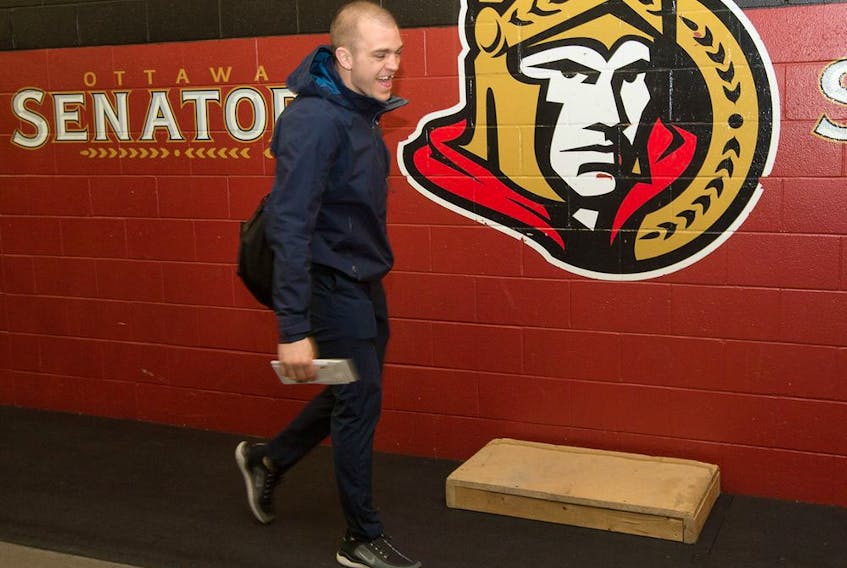 Mark Borowiecki walks past the Sens logo as the Ottawa Senators wrap up their season by clearing out their lockers and head home.  