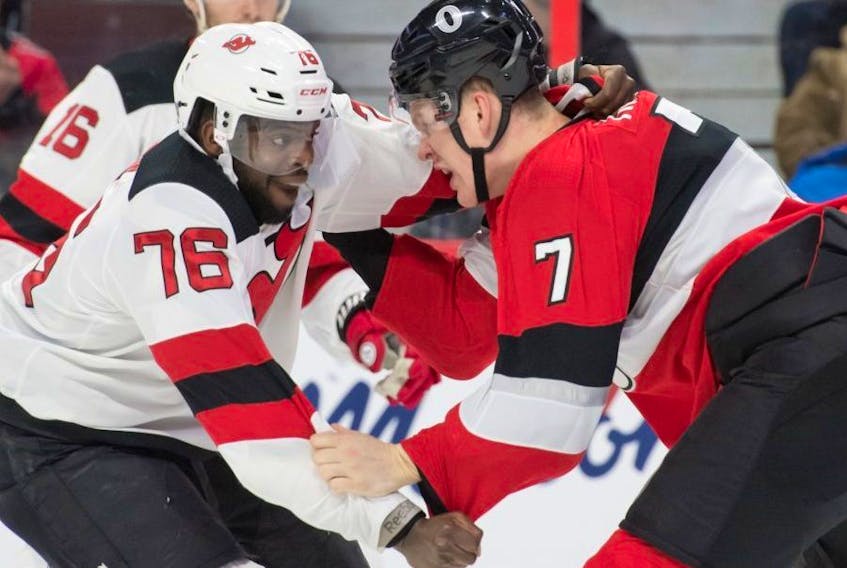 New Jersey Devils defenceman P.K. Subban (left) fights with Ottawa Senators forward Brady Tkachuk last night. (USA TODAY)
