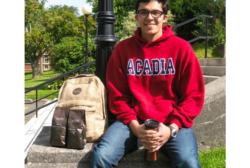Acadia University student and business owner Sergio Garrido poses on the steps of University Hall with his Aroma Mayo coffee and new backpacks from Guatemala. FILE