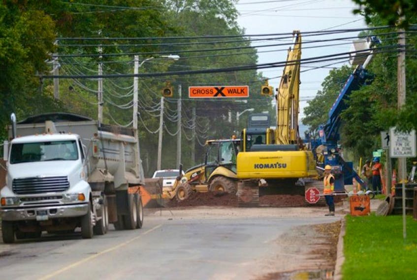 Work crews have part of North River Road blocked off Wednesday as work continues on the city's sewer extension project.