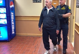 Dennis Murphy leaves a St. John's courtroom accompanied by a sheriff's officer June 17, 2019.