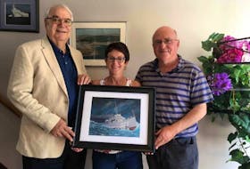 Kenneth Pravit, left, presented a framed painting of the USS Truxtun to St. Lawrence Advisory Historical Committee chairperson Laurella Stacey and former St. Lawrence mayor and historian Wayde Rowsell. Pravit’s cousin, Kenneth Landry, was killed when the American navy ship sank off the Burin Peninsula on Feb. 18, 1942.