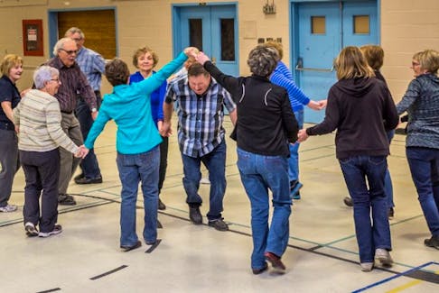 Dancers having a great time ‘threading the needle’ – the final set of the square dance.