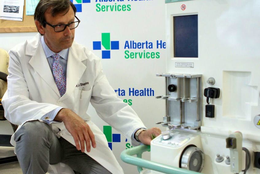 Dr. James Shapiro, a liver transplant surgeon with the University of Alberta and director of the Clinical Islet and Living Donor Liver Transplant programs with Alberta Health Services, inspects the OrganOx Metra portable ex-vitro perfusion device - the first of its kind in North America - at the University of Alberta Hospital on Wednesday, March 18, 2015. PHOTO BY CLAIRE THEOBALD/EDMONTON SUN.