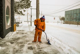 Gerald Rogers, a maintenance worker at the McDonald's regional office on Dorchester Street in Sydney, shovels the office's sidewalk during the Friday snowstorm, on March 19, 2021. JESSICA SMITH/CAPE BRETON POST