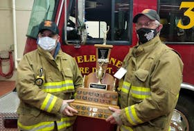 Chris Ross (left) is presented with the Firefighter  of the Year award for the Shelburne Volunteer Fire Department by Chief Darrell Locke. Contributed

