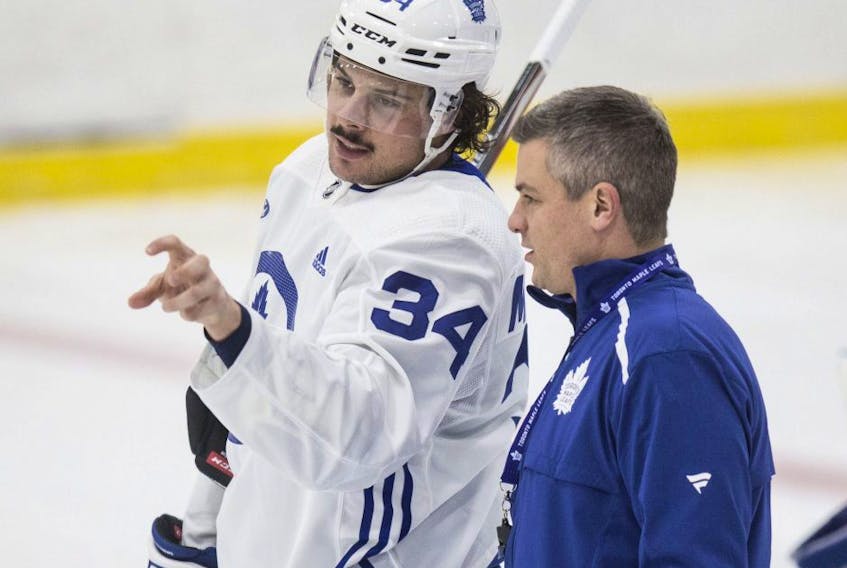 Maple Leafs head coach Sheldon Keefe and Auston Matthews talk at practice at the Ford Performance Centre in Toronto on Monday, Nov. 25, 2019.